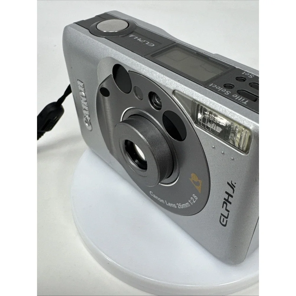 CANON Elph Jr. APS Film Camera, 26mm‎ f2.8 Wide Angle Lens, Silver w/ Case WORKS
